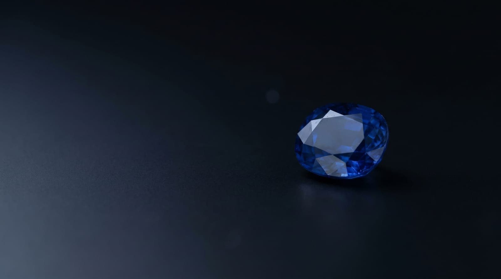 Precision-cut blue sapphires arranged on a sorting tray