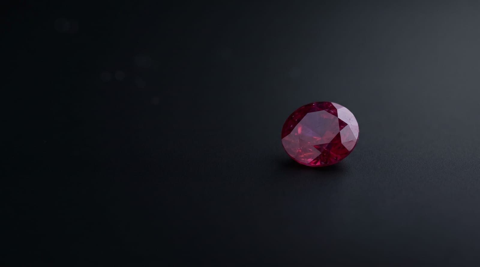 Gemologist examining a ruby under magnification for synthetic indicators at a Bangkok gem lab